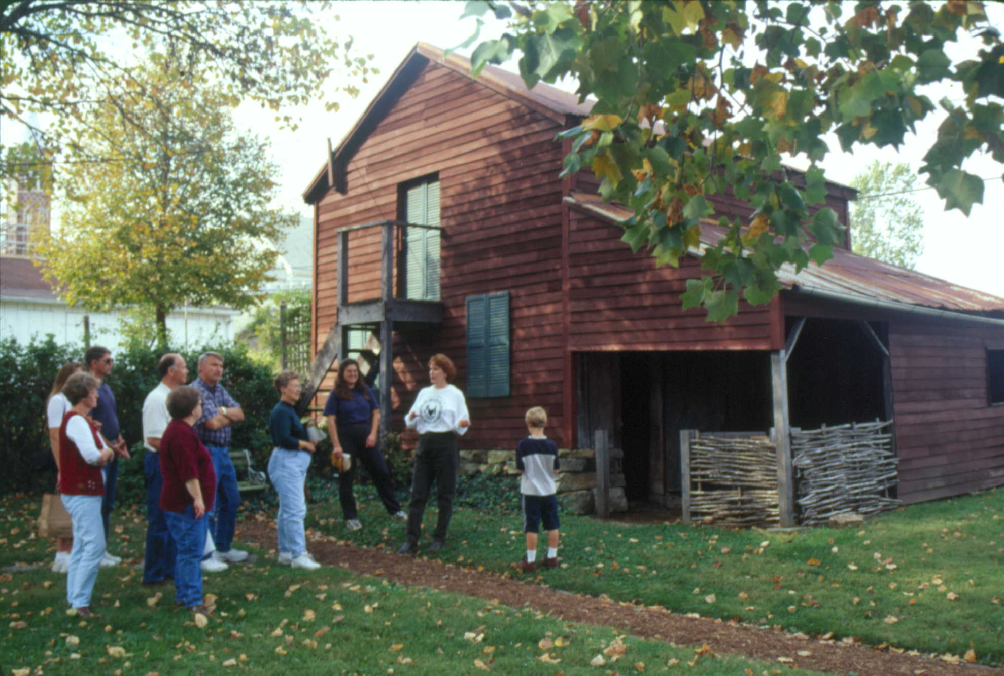 a group of people on a tour in front of the Gentner barn