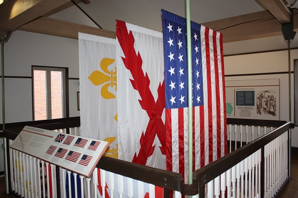 various flags hanging in the stairwell of the visotr center
