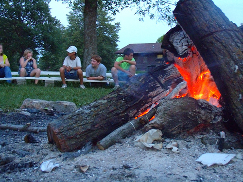 kids sitting around a campfire