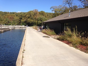 Exterior of the fish hatchery next to one of the pools where the fish are raised