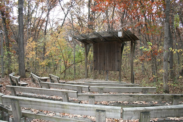 wood benches and stage area in amphitheater 