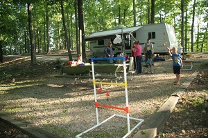 people playing hillbilly golf in front of their camper