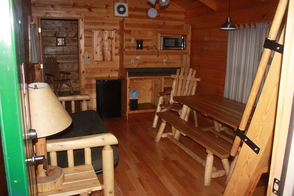 table and futon inside a camper cabin