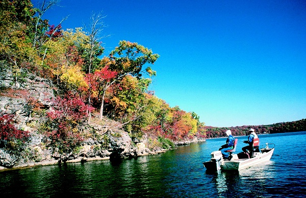 two men in a boat fishing near the shore of the Lake of the Ozarks