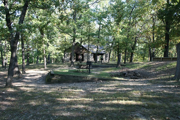 shelter and picnic tables in shaded area 