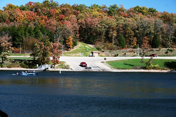 someone launching a boat on the paved ramp