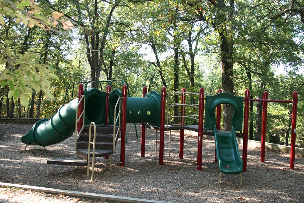 playground with slides in a shaded area