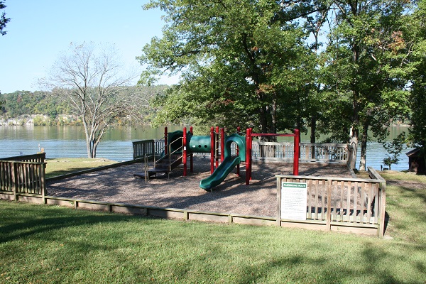 slide/playground aparatus on a raised area of pea gravel