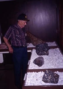 a man looking at some of  the minerals on display