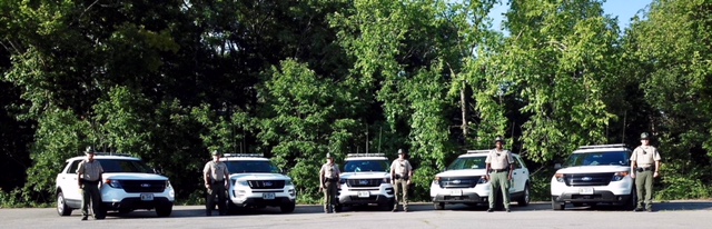 rangers standing by their ranger vehicles