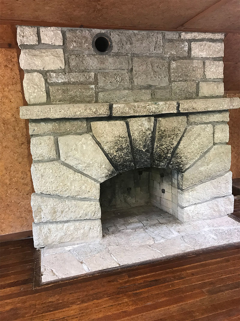 Stone fireplace inside dining lodge