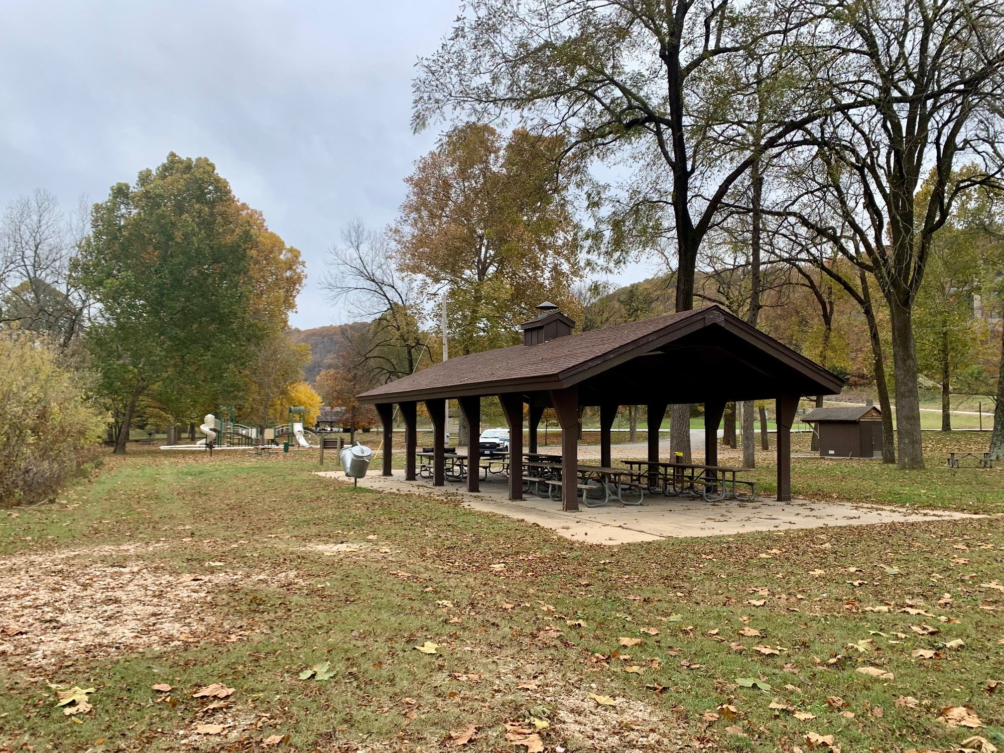 Open picnic shelter, trashcans, bathroom and playground