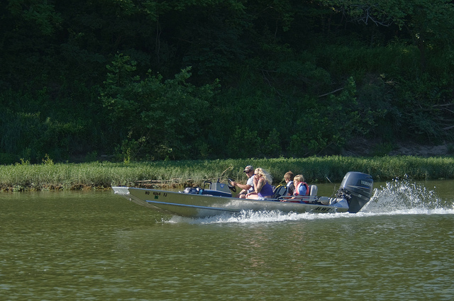 several people in a boat on the river