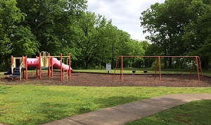 playground equipment with slides and a swing set