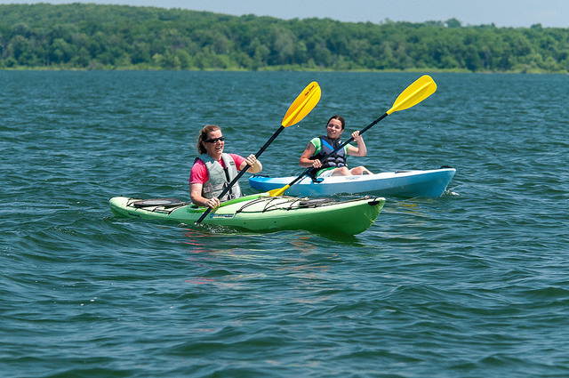 two woman in kayaks on a lake