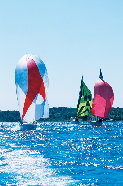 three sailboats on the lake