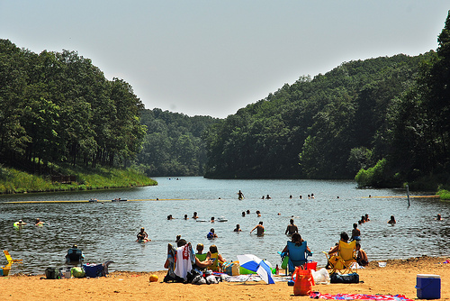 People on the beach and swimming in the lake