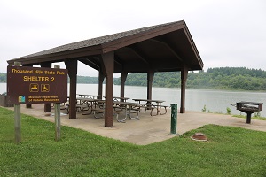 shelter with large grill next to the lake