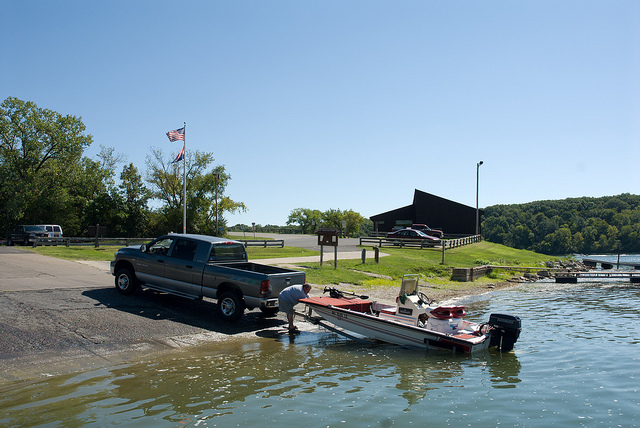 a truck unloads a boat at the concrete boat ramp