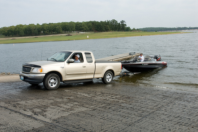 a truck unloading a boat using the concrete boat ramp