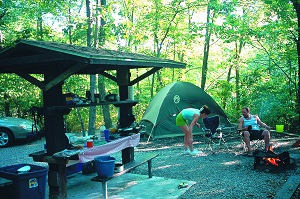 a couple cooking outside their tent