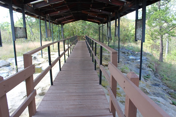 a boardwalk and shelter that leads to the petroglyphs
