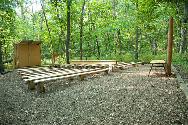 wooden benches and a stage area at the amphitheater