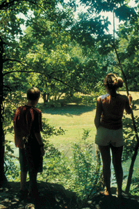 two kids stand on the bluff overlooking the spring